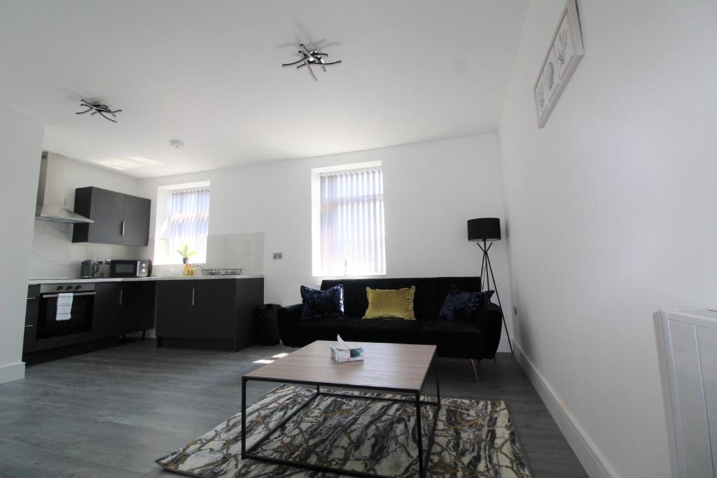 a living room with a couch and a table at F6 Hammonds Row in Preston