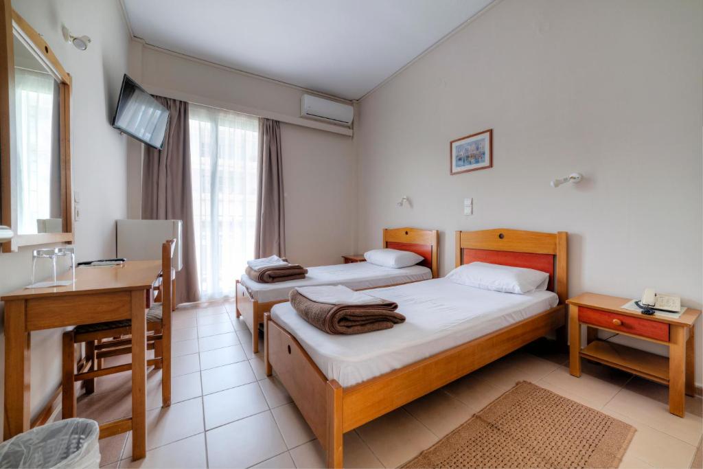 Postel nebo postele na pokoji v ubytování Delfini Hotel