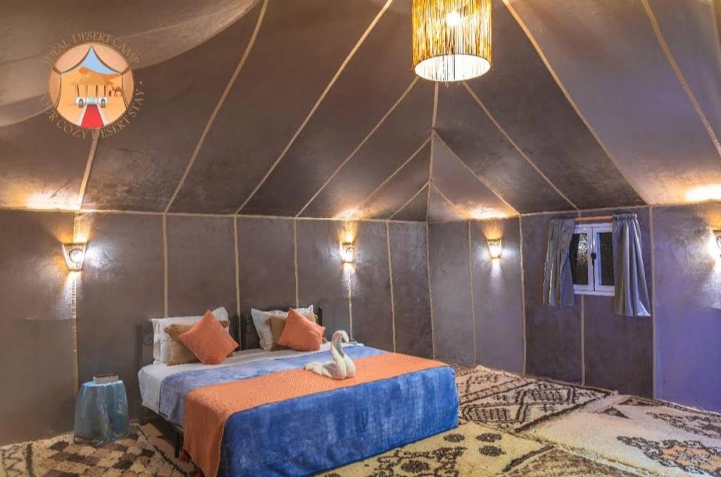 a bedroom with two beds in a tent at Morocco tours camp in Merzouga