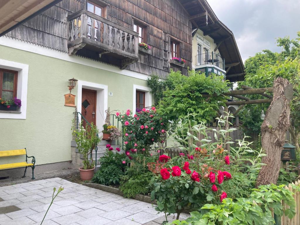 a garden in front of a house with flowers at Schreiner in Wernstein am Inn