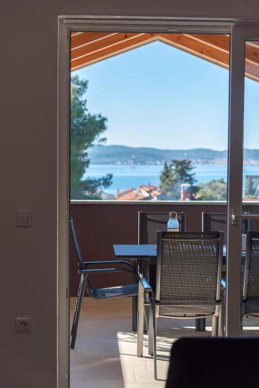 a view of a balcony with a table and chairs at Apartmani Lavanda in Bibinje