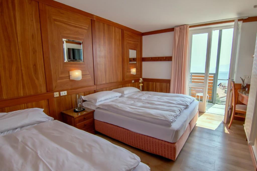 Postel nebo postele na pokoji v ubytování Hotel Miralago