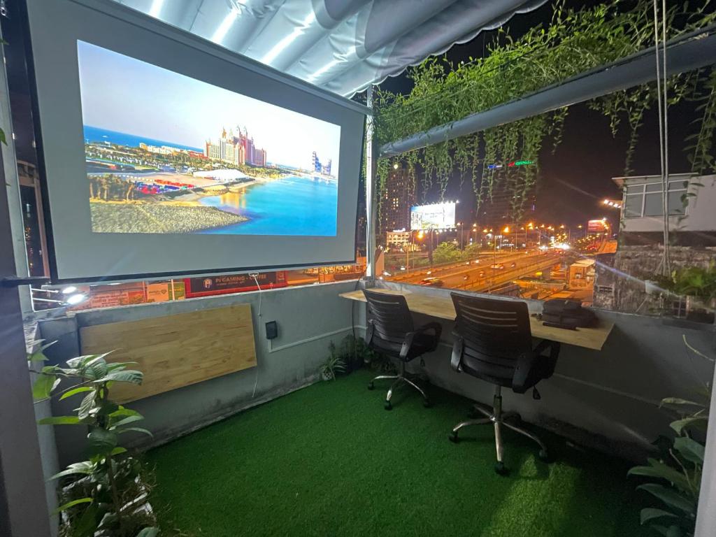 a room with two chairs and a projection screen at Sky Space Bến Thành in Ho Chi Minh City