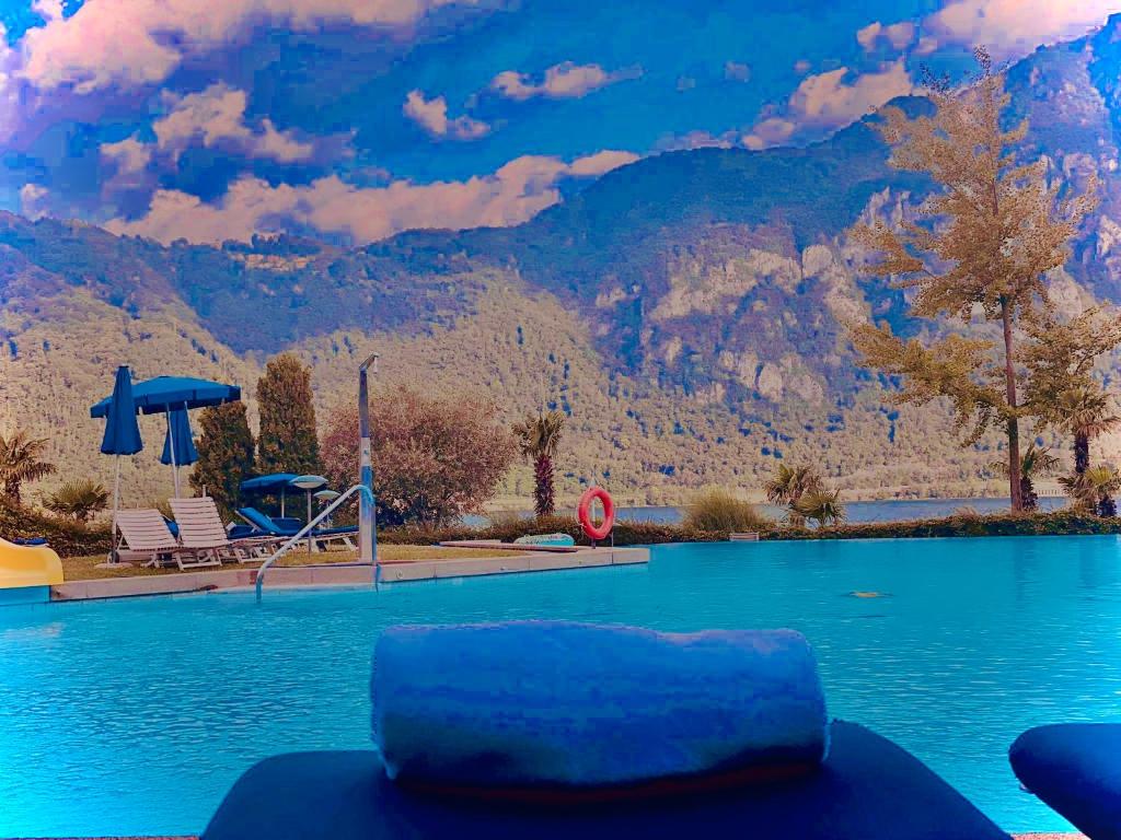 a pool with a view of a mountain at Lake Apartment 4 in Bissone