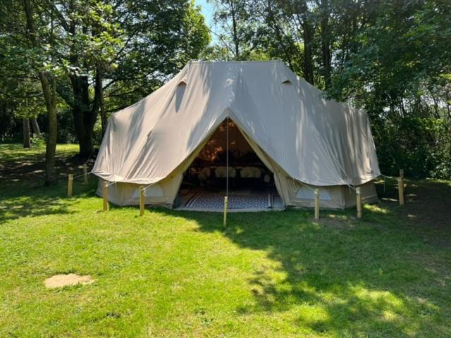 a tent in the middle of a field at Superior Luxury Large Emperor Tent in Stoke Goldington
