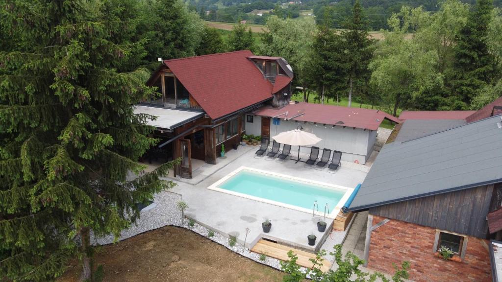 an aerial view of a house with a swimming pool at Lake House with a View in Šmartno v Rožni Dolini