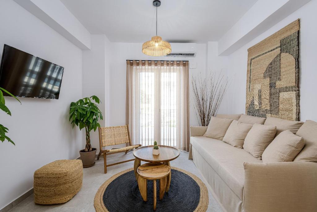 ein Wohnzimmer mit einem Sofa und einem Tisch in der Unterkunft Suites 33 in Kos-Stadt