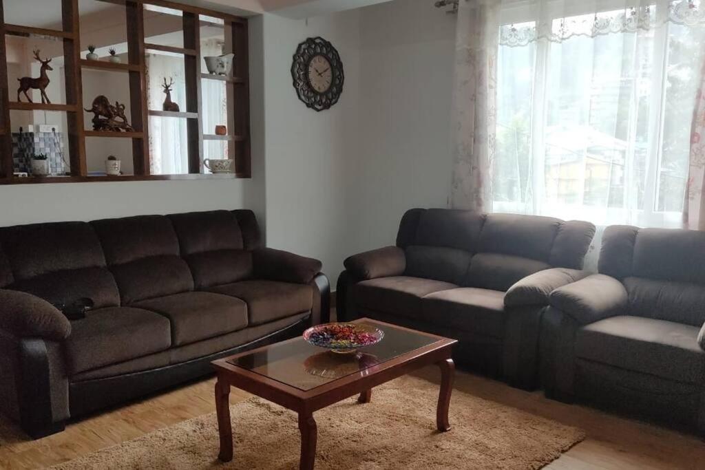 a living room with two couches and a coffee table at Shiloh Khim in Gangtok
