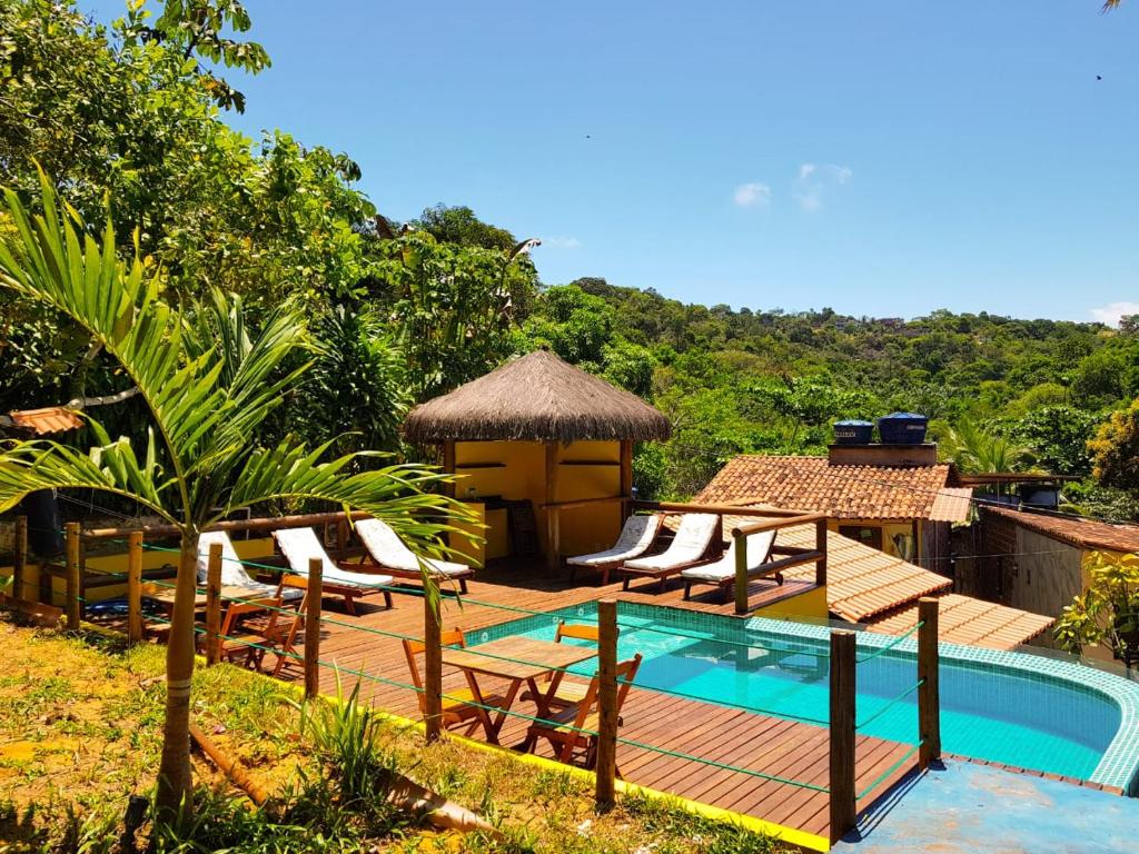 a resort with a pool and chairs and a gazebo at Odoya Morro de São Paulo in Morro de São Paulo