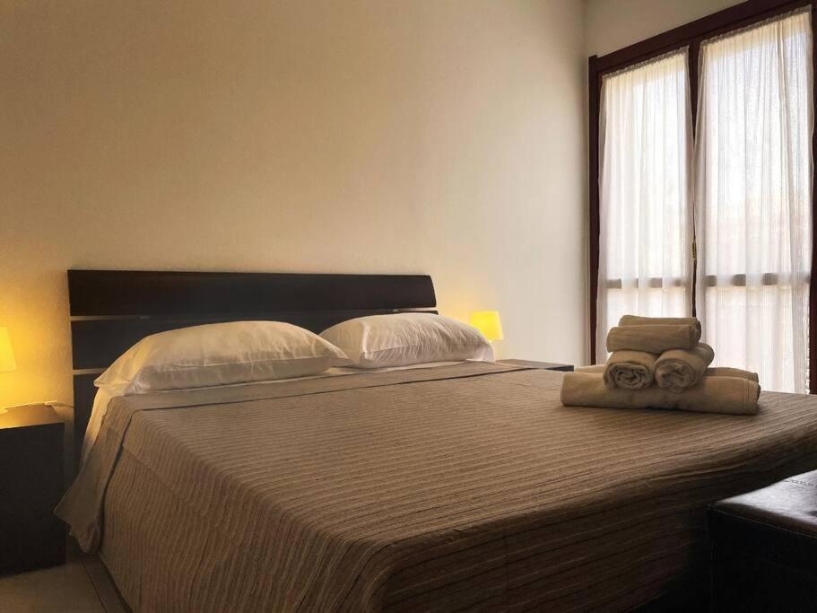 a bedroom with a large bed with towels on it at Apt. Montesanto Sunset, 300Mt from city centre. in Pula
