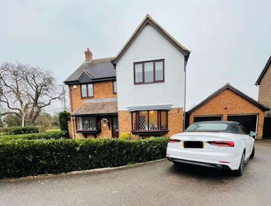 a white car parked in front of a house at Lovely modern, well-kept house in Sidcup