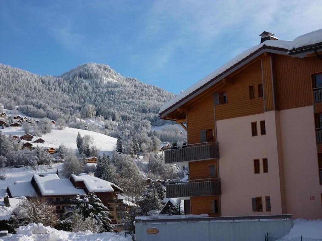 a ski lodge in the mountains with snow on the ground at appartement in de Haute Savoie (Saint Jean de Sixt) in Saint-Jean-de-Sixt