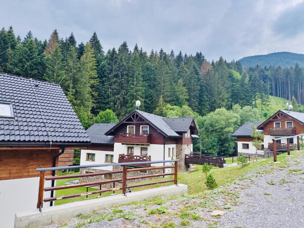a group of houses with trees in the background at Apartmán Paseky in Terchová