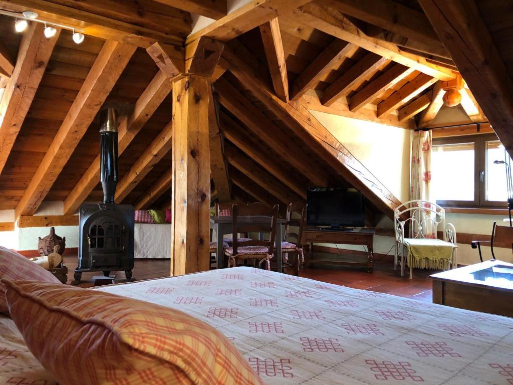 a room with a bed and a wood stove at Apartamentos Lobiche in Navafría