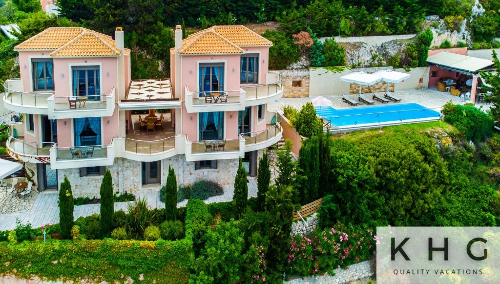 an aerial view of a house with a swimming pool at Elli's Villas complex in Petani beach! Majestic wide angle sea views along Petani beach! in Vóvikes