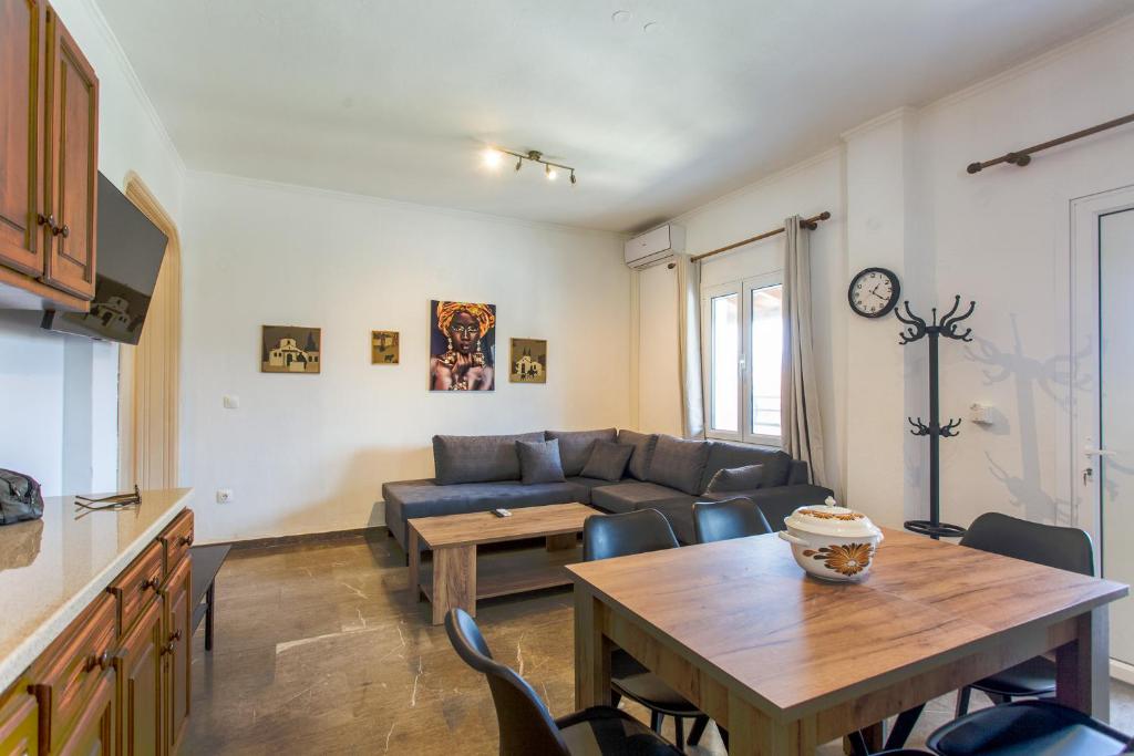 a living room with a couch and a table at Kampos Kassiopi Apartment in Kassiopi