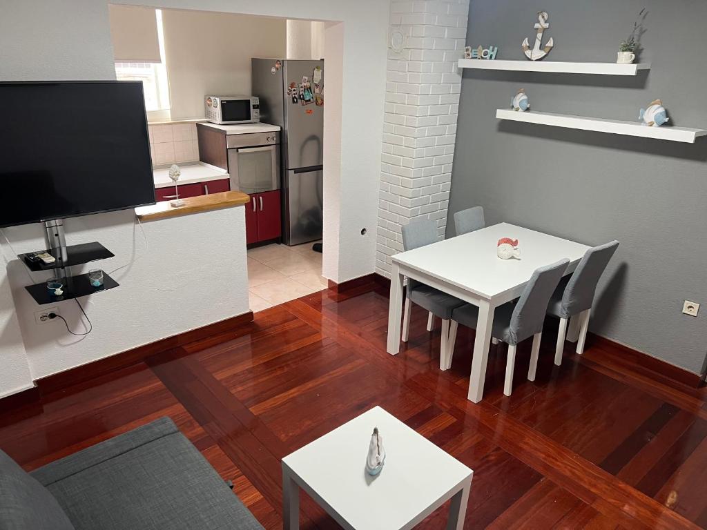 a living room with a table and a kitchen at Apartmani Kacola in Tučepi