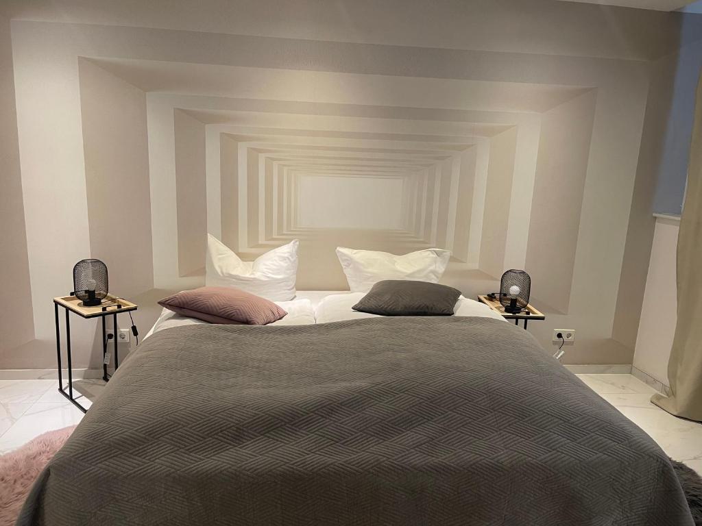 a bedroom with a large bed with two tables at Moderne, ruhige Ferienwohnung in der Stadtmitte in Hadamar