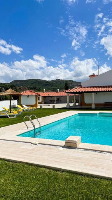 a swimming pool in the yard of a house at Sitio Terra do Loureiro in Porto de Mós