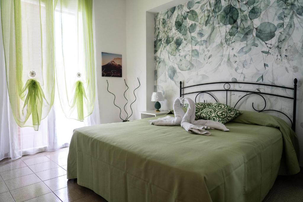 een slaapkamer met een bed met twee knuffels erop bij Mirador Savoca in Savoca 