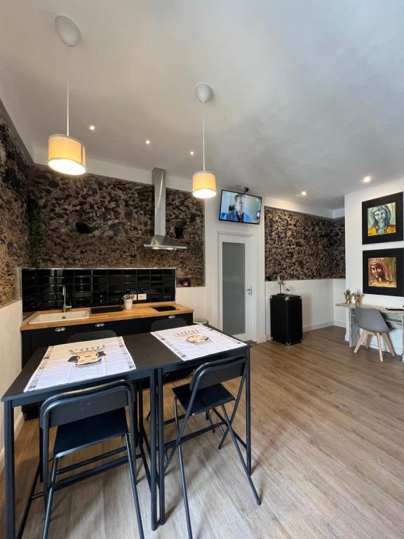 a kitchen with a table and chairs in a room at Bibike in Catania