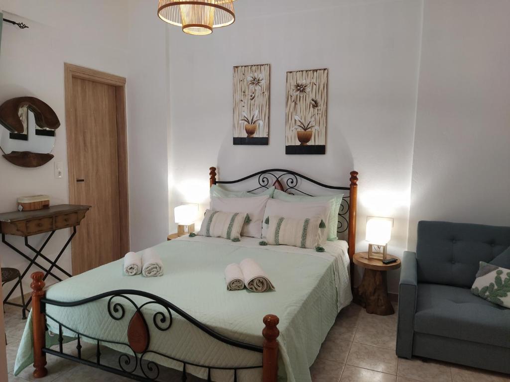 a bedroom with a bed and a blue couch at Vithos in Agnontas