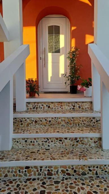 a front door of a house with a stone floor at Andreas' Guest House in Káto Spílaion