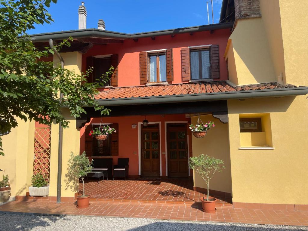 a house with a brick patio in front of it at Spacious House in Venezia with Free Parking in Zelarino