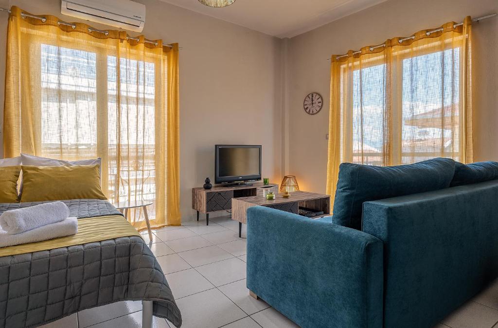 a living room with a couch and a tv at Cozy Spot apartment in Preveza