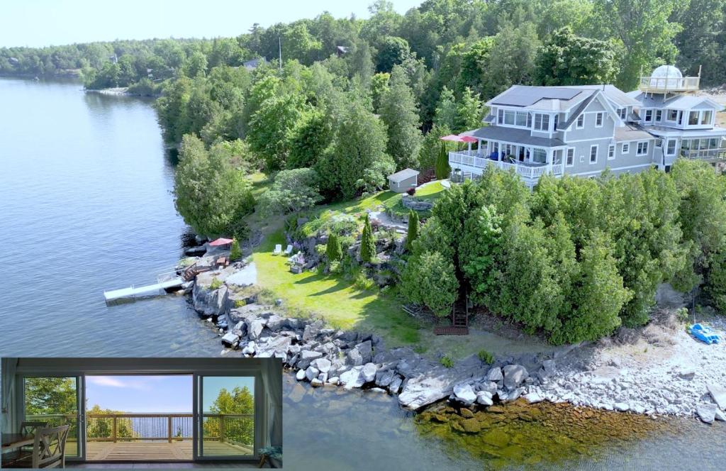 a large house on an island in the water at Loza house coastal design unit with lake & mountain views in Plattsburgh