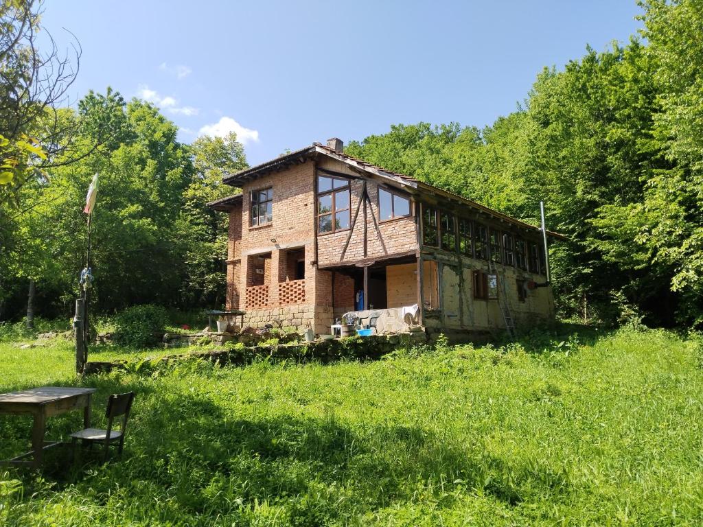 an old house in the middle of a field at Balkan Mountains Villa Spa in Elena