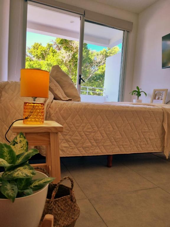 a living room with a couch and a window at Depto Zona Plaza Paso con opcion de Cochera byLofter in La Plata