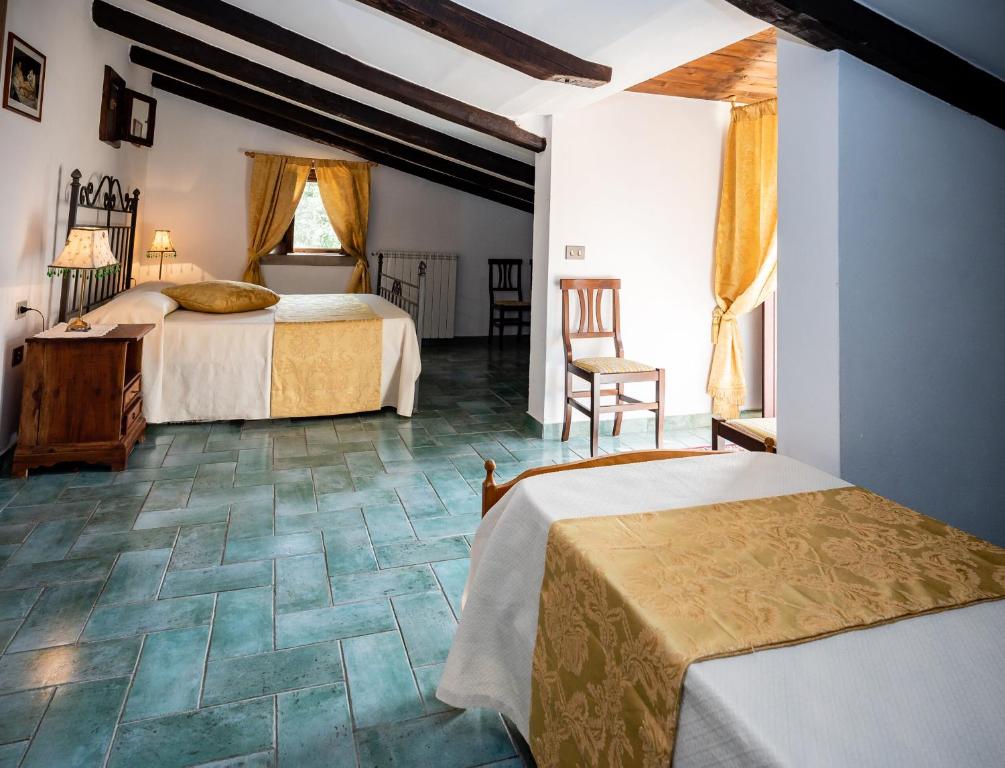 皮肖塔的住宿－La Locanda del Fiume，一间卧室配有两张床和一张桌子及椅子