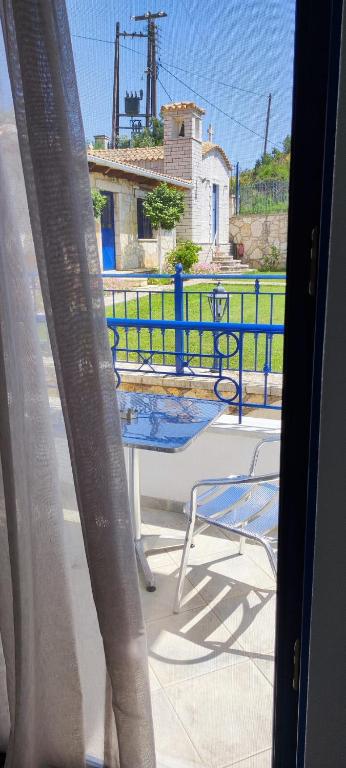a view of a table and chairs from a window at Villa Rodanthi Sivota in Syvota