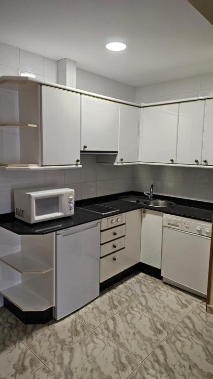 A kitchen or kitchenette at Apartamentos Coral Do Mar I