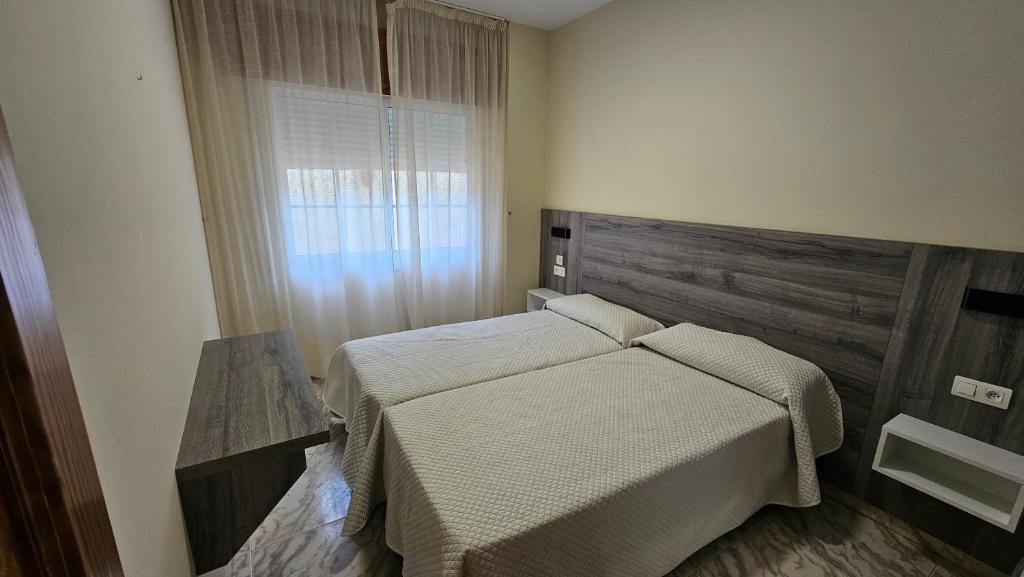 A bed or beds in a room at Apartamentos Coral Do Mar I