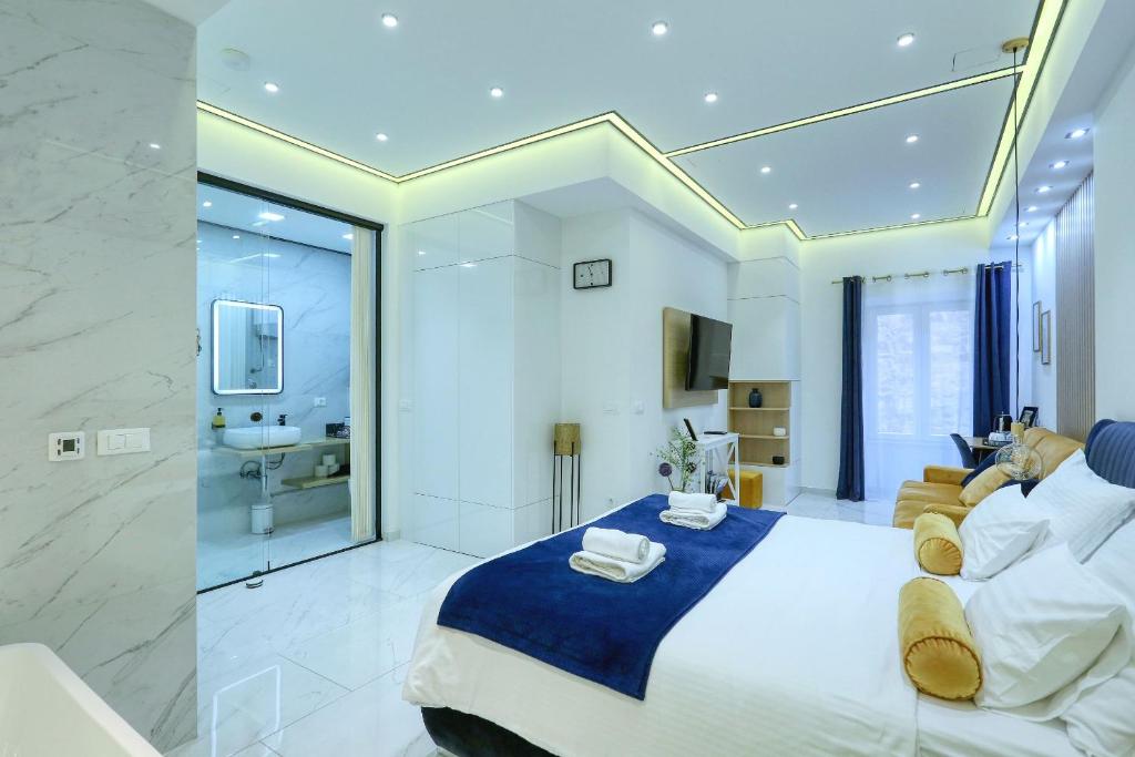 a bedroom with a large bed and a bathroom at RINO LUXURY ROOM in Zadar