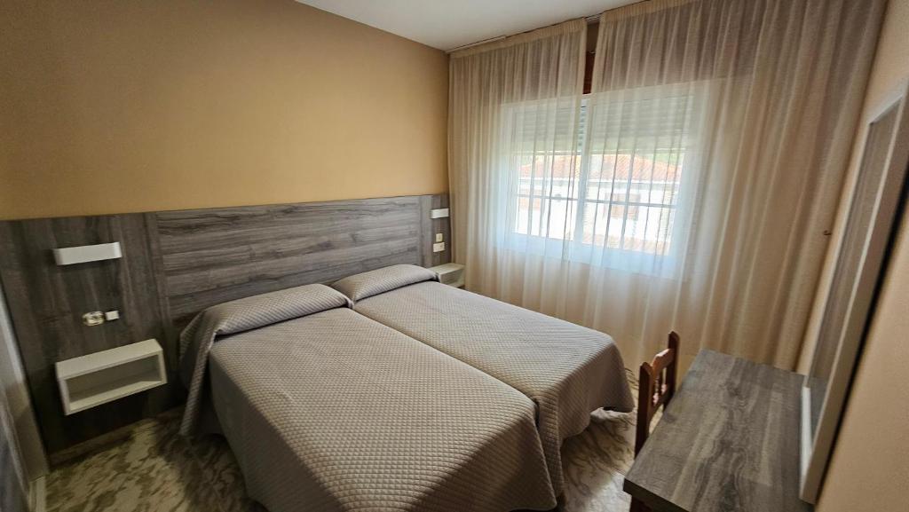 A bed or beds in a room at Apartamentos Coral Do Mar I
