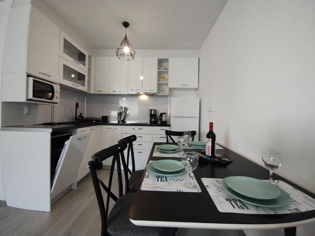 uma cozinha com uma mesa com placas verdes em Apartament Sea Fort Club Grand Resort Fort Noks Sveti Vlas-Bastet BS em Elenite