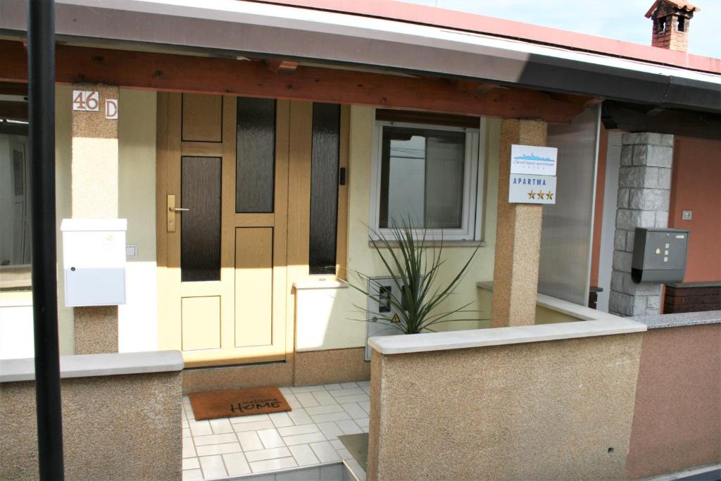 a front door of a house with a sign on it at Small house apartment in Koper