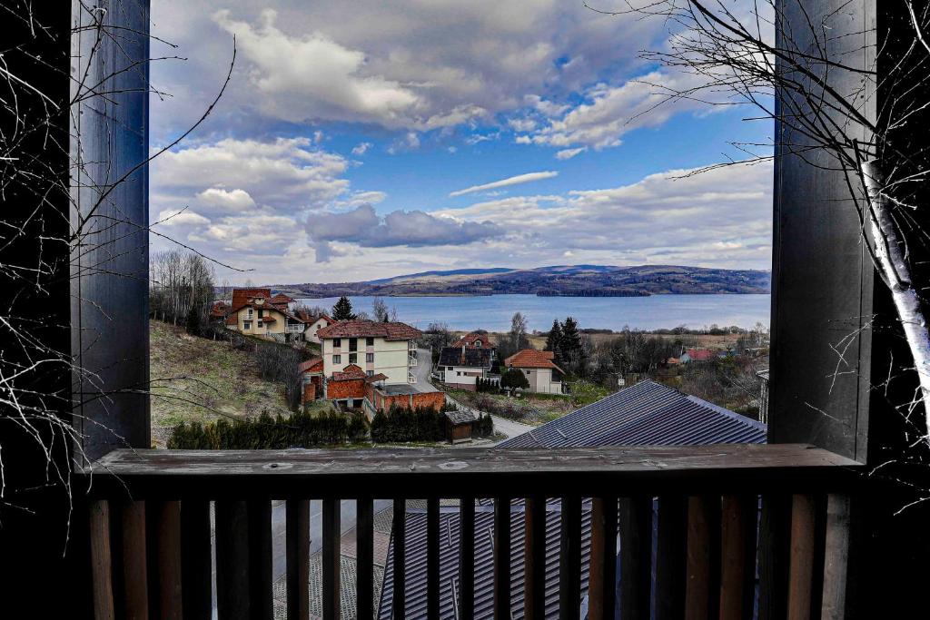 a balcony with a view of a town and a lake at Vlasinsko jezero VILA BEST in Surdulica