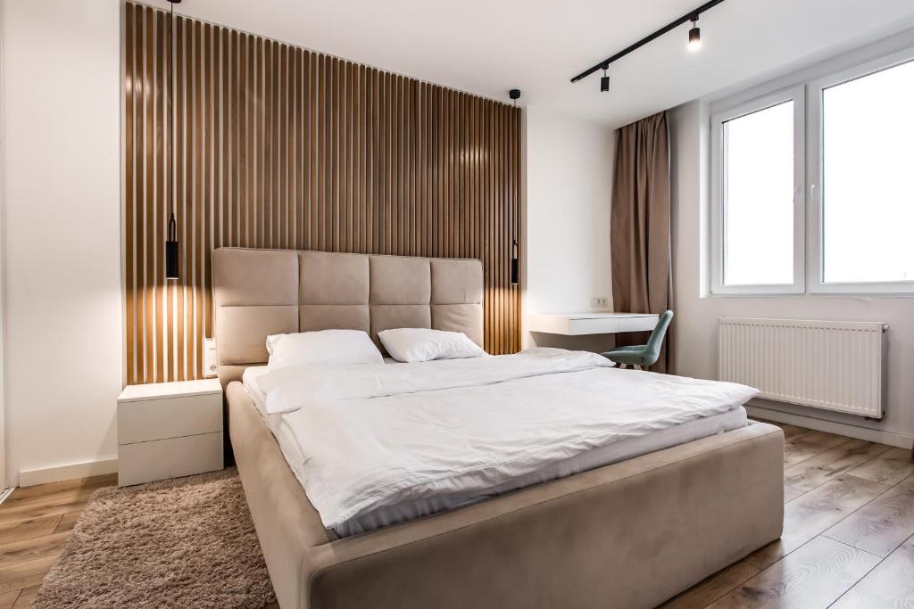 a bedroom with a large bed and a desk at VIP Apartments in Lviv