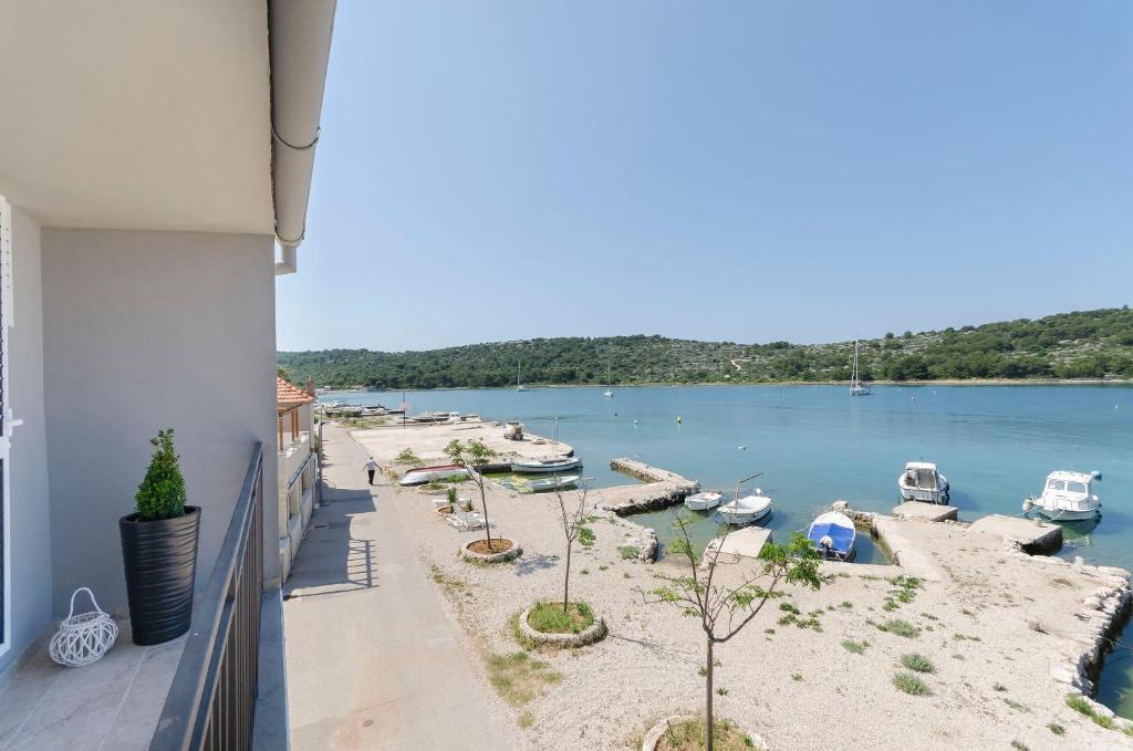 een balkon met uitzicht op een rivier en boten bij Apartment Paradise in Kaprije