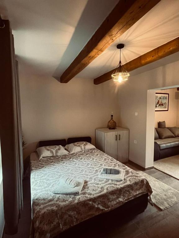 a bedroom with a bed and a couch at Old wine in Virpazar