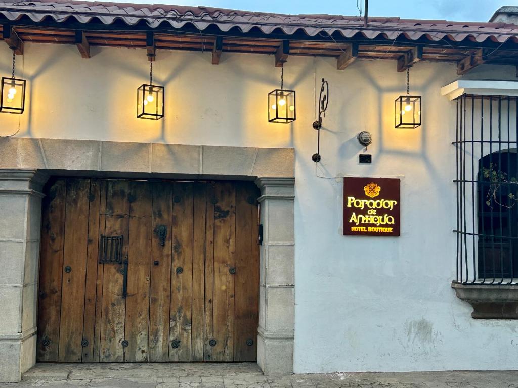 a building with a wooden door and a sign on it at Parador de Antigua in Antigua Guatemala