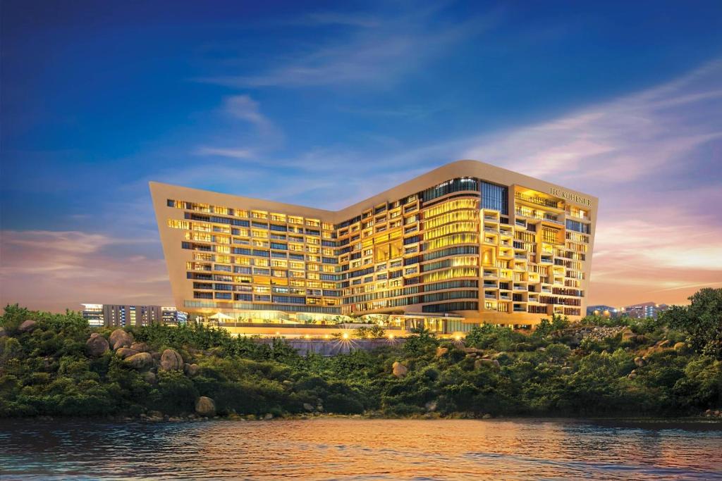 a rendering of a building next to a river at ITC Kohenur, a Luxury Collection Hotel, Hyderabad in Hyderabad
