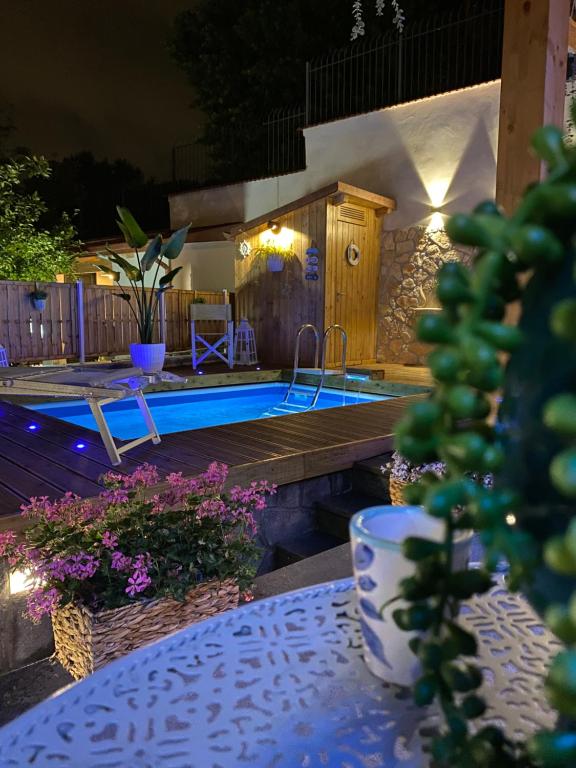 a backyard with a swimming pool at night at Villa LORY in Castellammare di Stabia