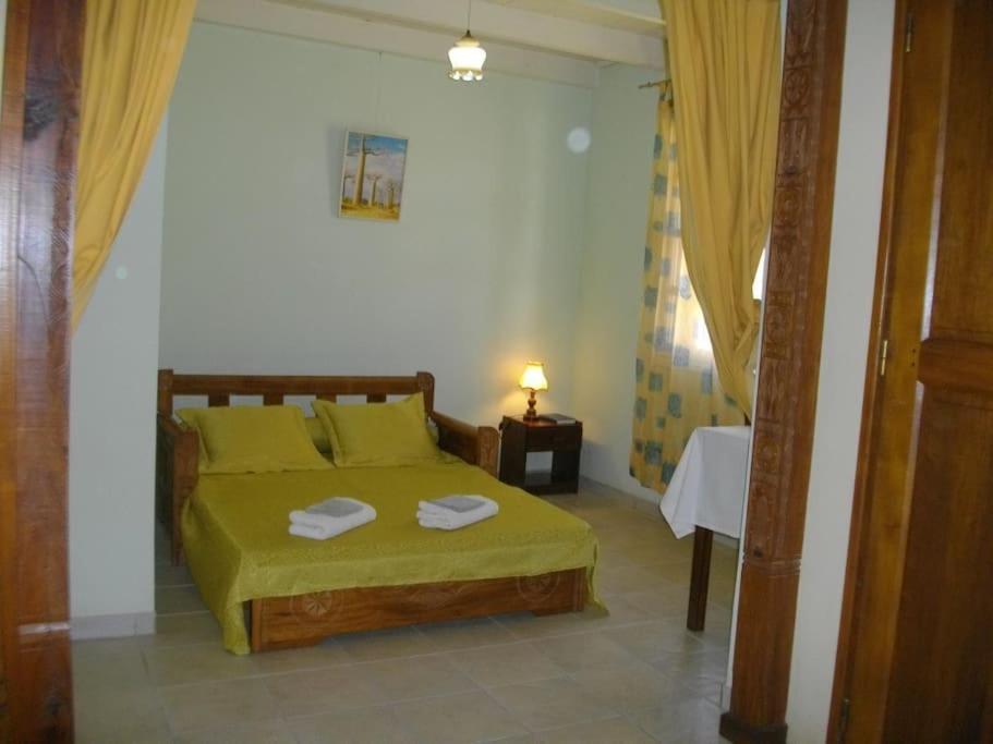 a bedroom with a bed with two towels on it at Villa Herifanja Antsirabe in Antsirabe