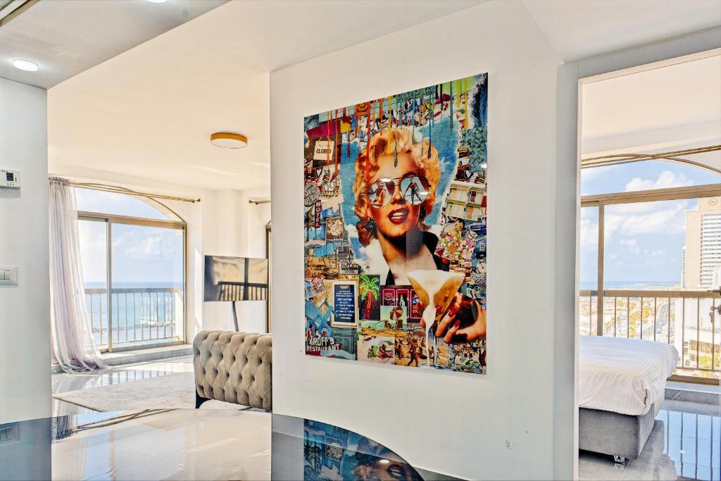 a living room with a large painting on the wall at Orchid sea view apartment in Tel Aviv