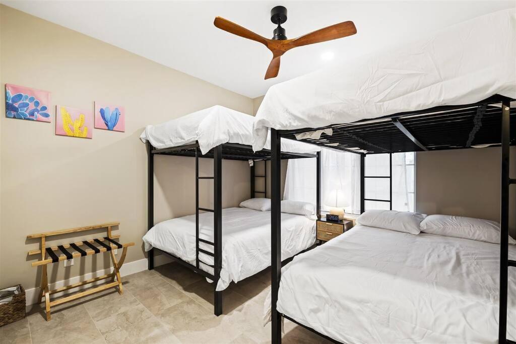 two bunk beds in a room with a ceiling fan at King Bed - High End -Westgate Villa. in Avondale